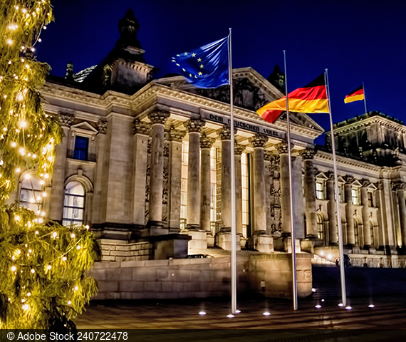  The Reichstag building in the background, Europe and Germany flag in the foreground.