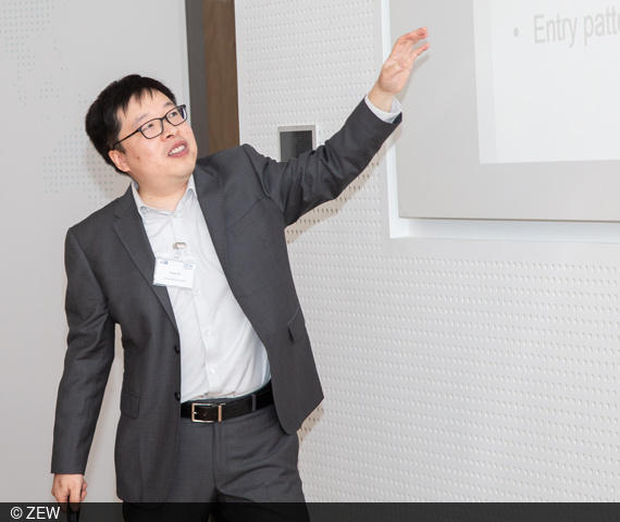 Feng Zhu referiert auf der 16. Konferenz zur digitalen Ökonomie