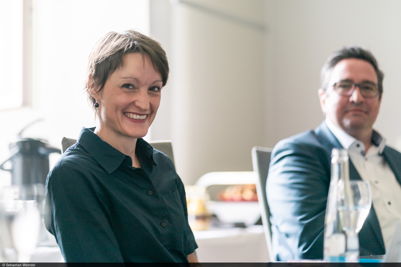 Professor Tabea Bucher-Koenen sits at the meeting table and laughs.