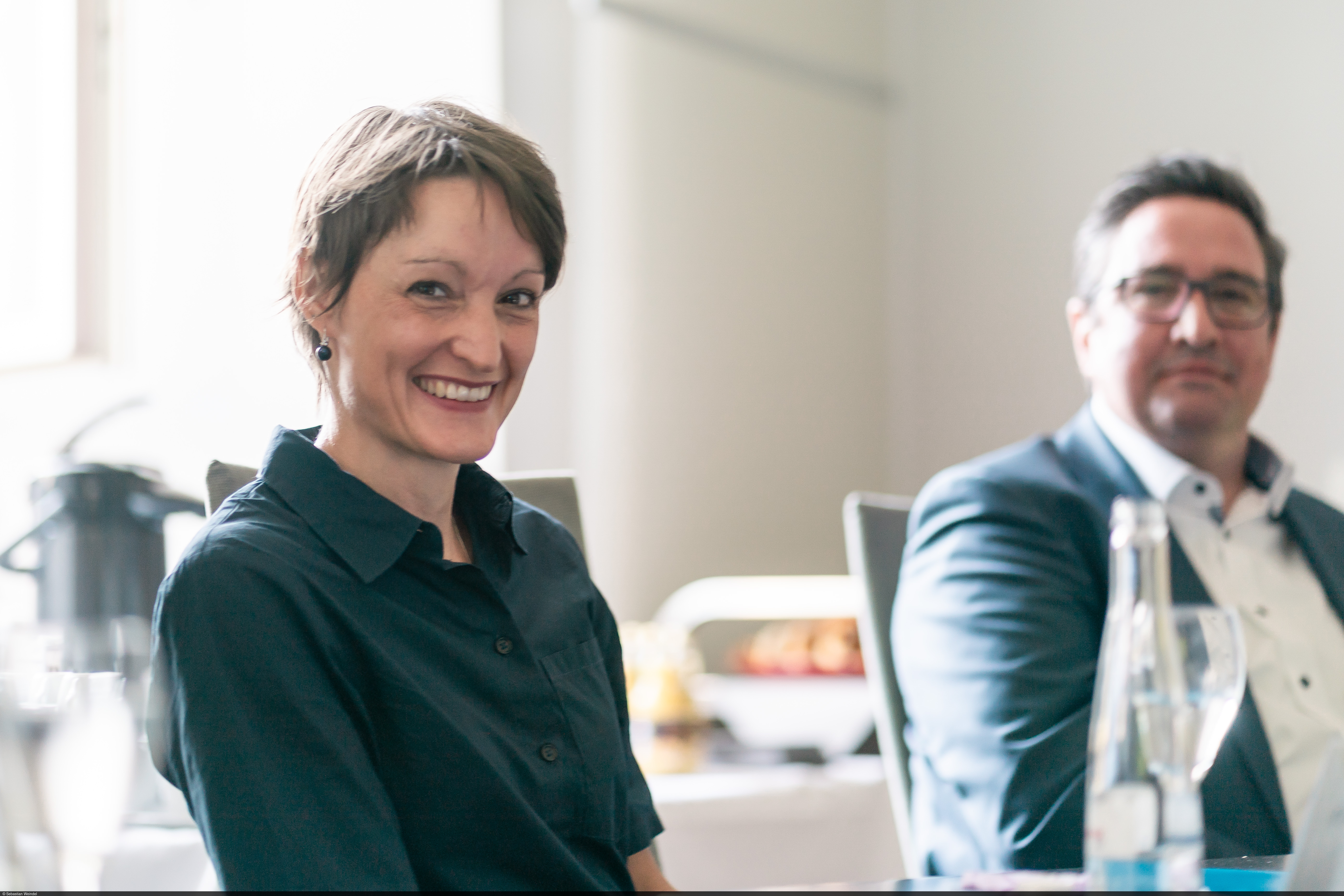 Professor Tabea Bucher-Koenen sits at the meeting table and laughs.
