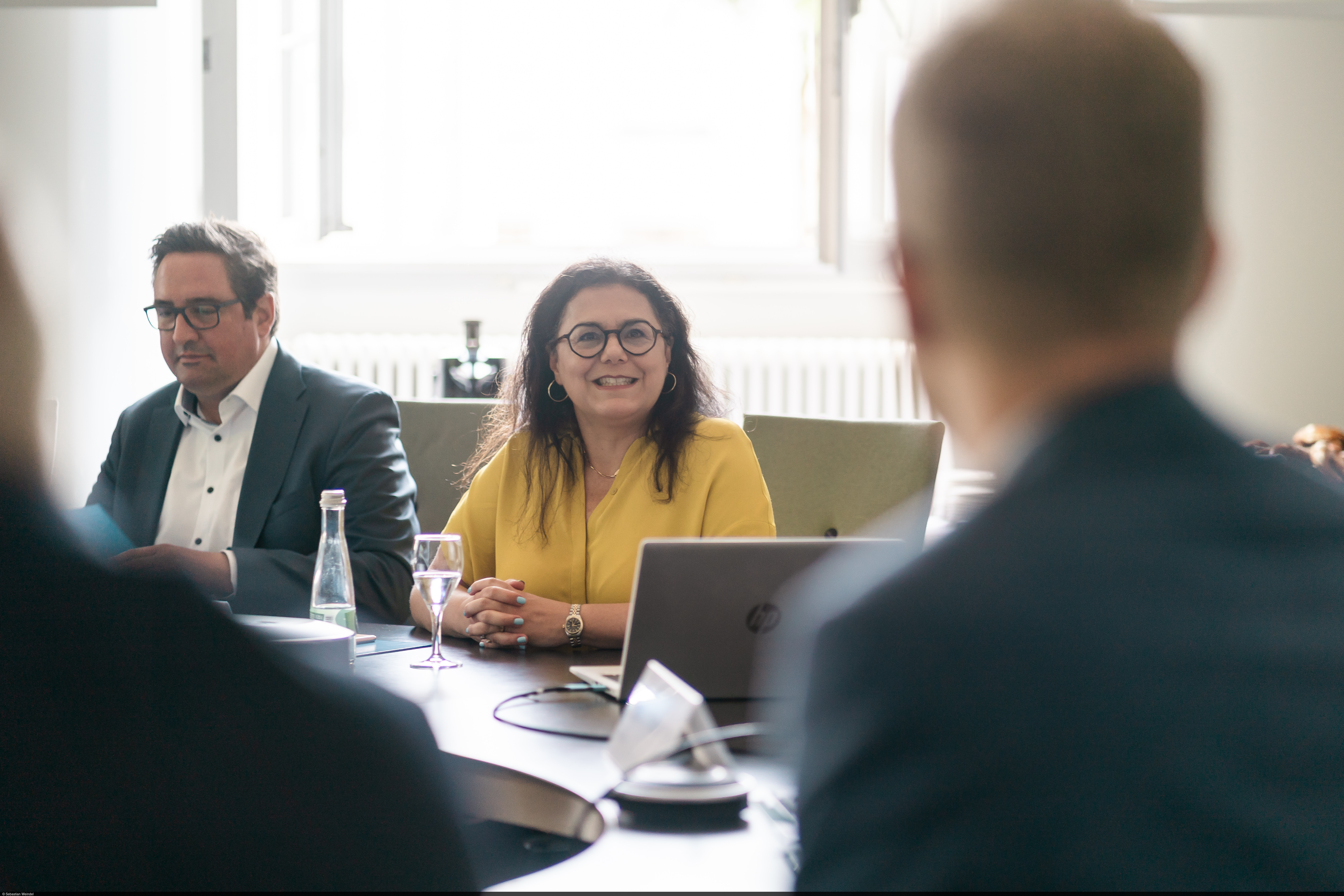 Professor Carmela Aprea sits at the meeting table.