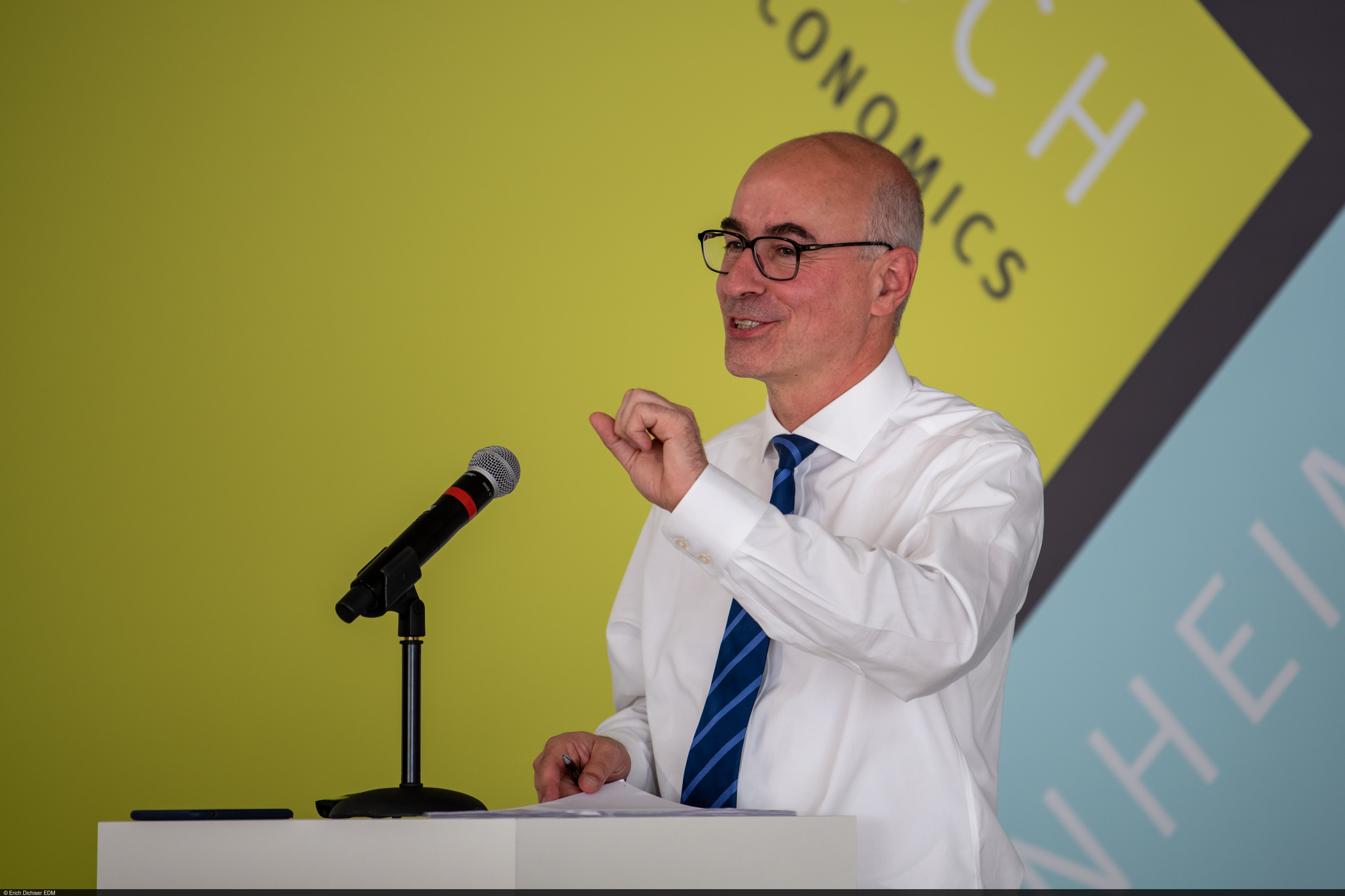 Achim Wambach behind the speaker's desk