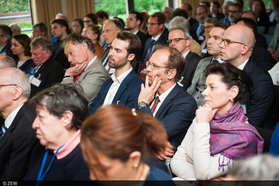 The audience follows the debate closely.