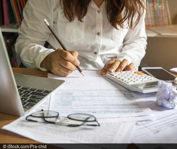 Symbol image with tax returns, woman and calculator.