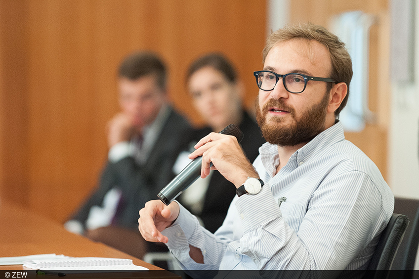 A participant of the ZEW Lunch Debate in Brussels asks a question from the audience