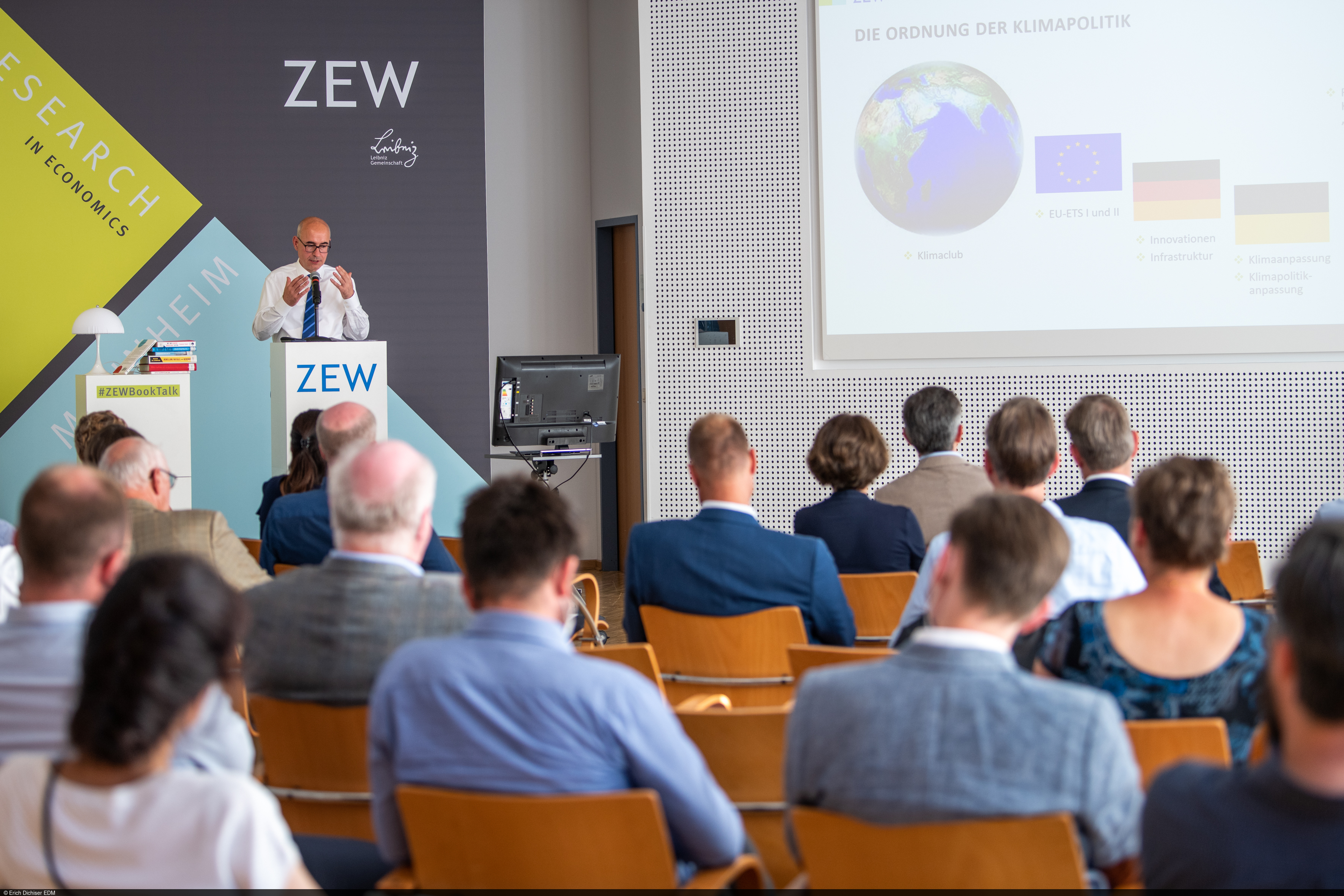 Achim Wambach speaks in front of the audience